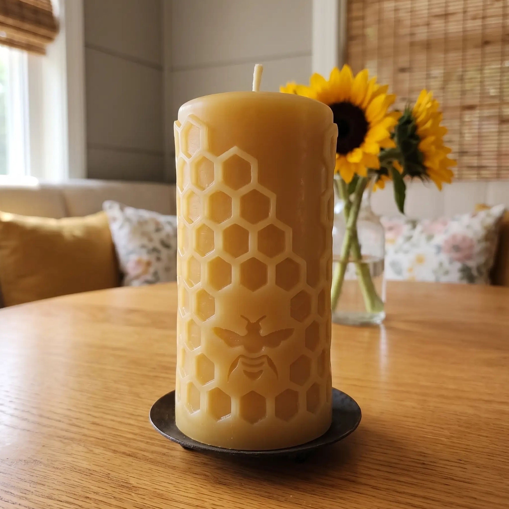 Honey Bee beeswax honeycomb pillar candle on a cozy breakfast nook table
