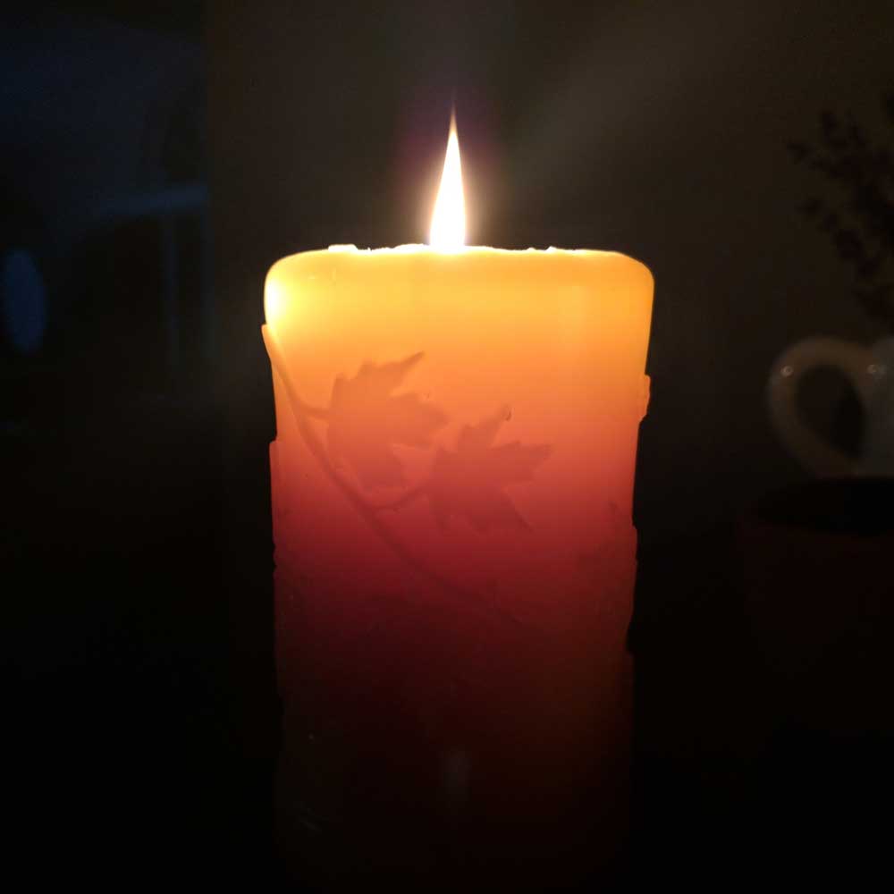 Beeswax candle with fall leaves design.