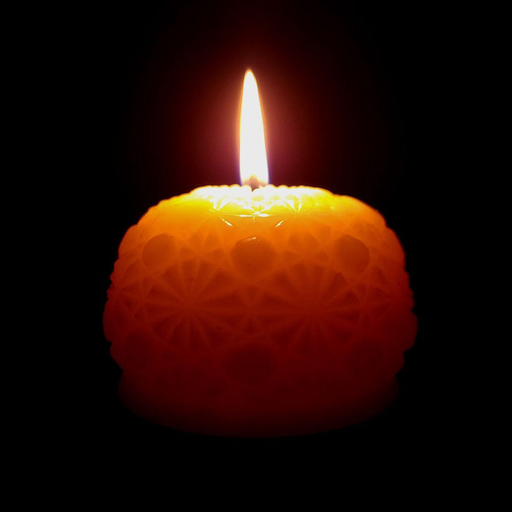 round beeswax candle burning