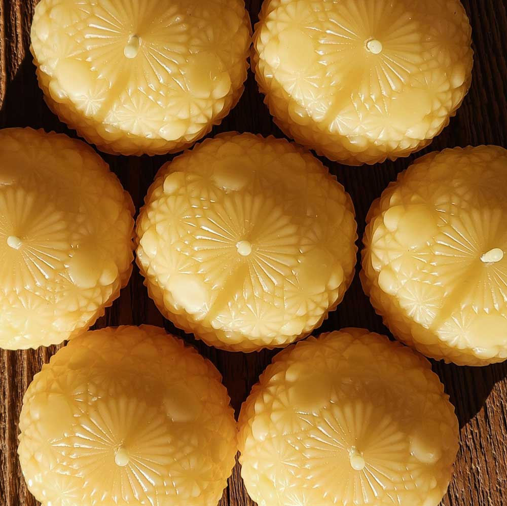 round beeswax candles in a honeycomb pattern