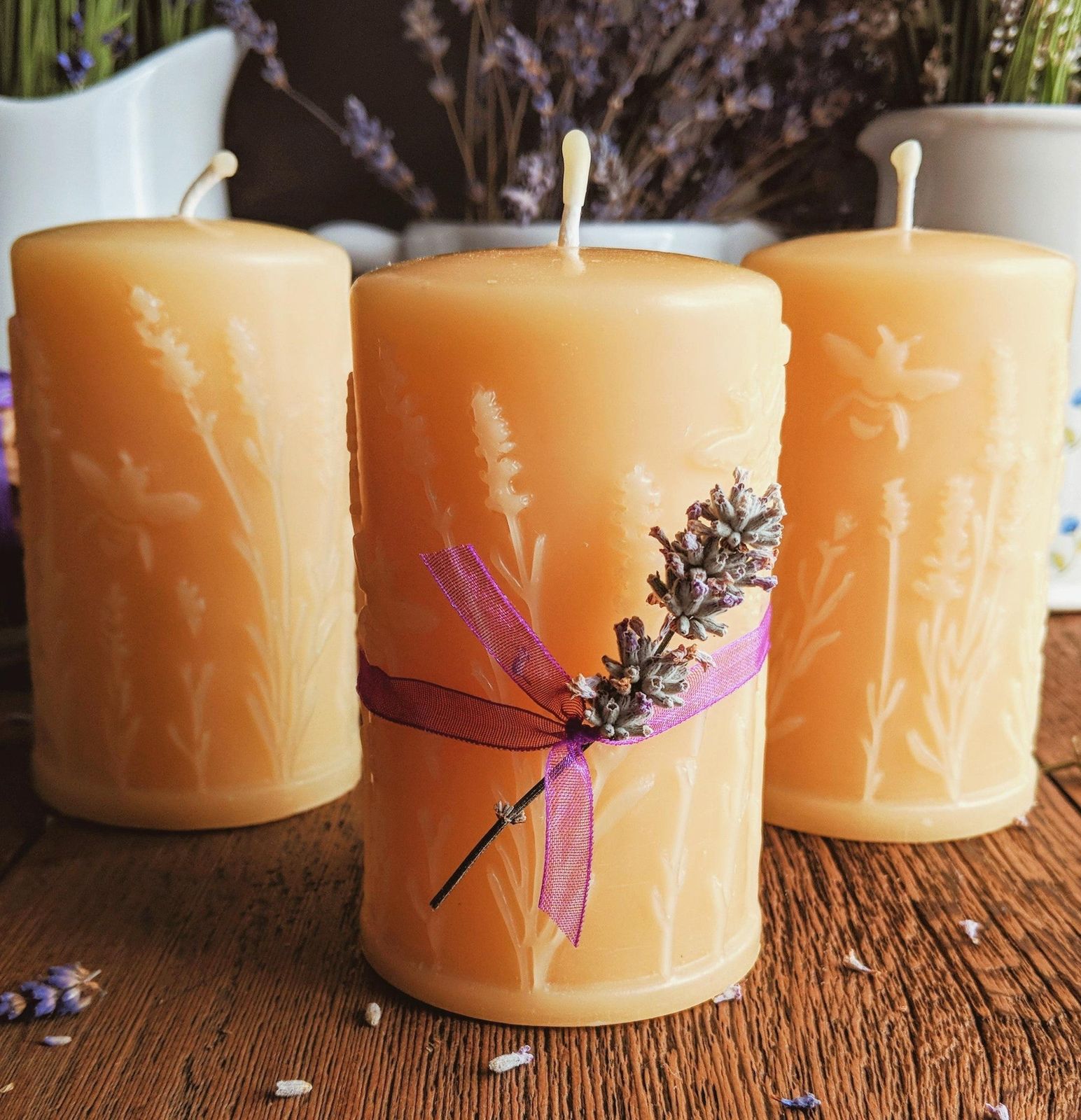 Beeswax pillar candles with pressed lavender at Big Moon Beeswax