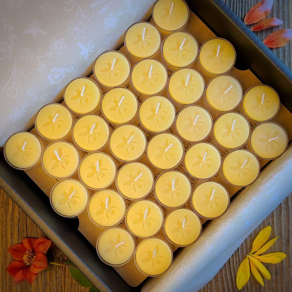 large box of yellow beeswax tealights with bee design on them