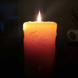 Beeswax candle with fall leaves design. 
