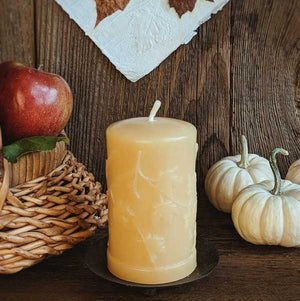 Beeswax pillar candle with maple leaves design. 