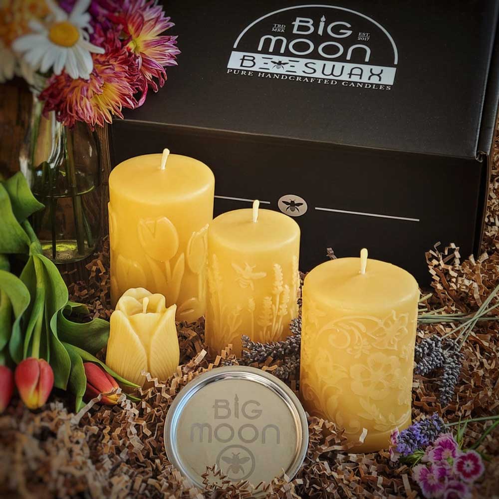 'Honey Bee's Garden' gift set: three flower-design beeswax pillars, a mini tulip candle, and a candle plate in a Big Moon Beeswax gift box