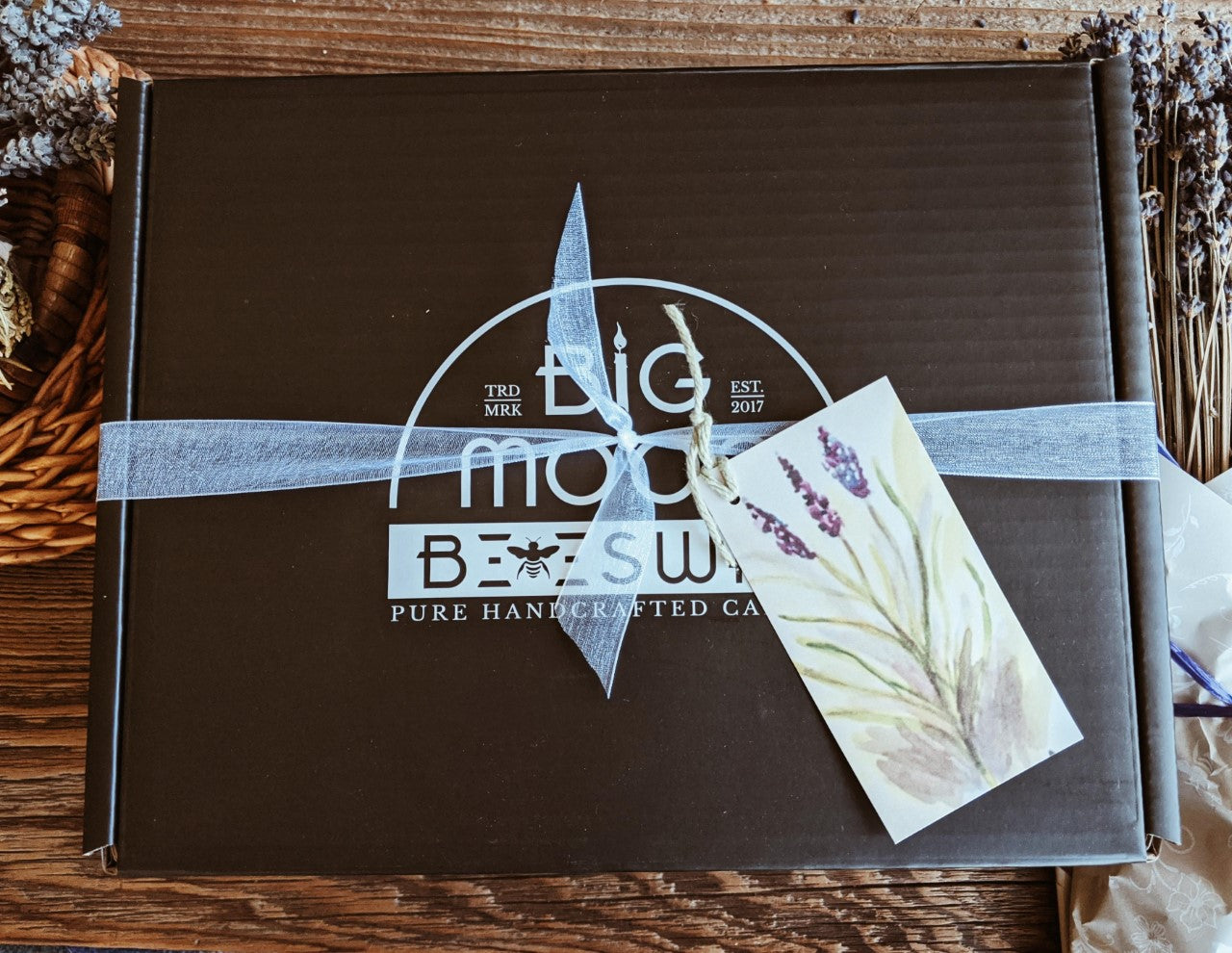 large black Big Moon Beeswax branded gift box tied with a white ribbon.