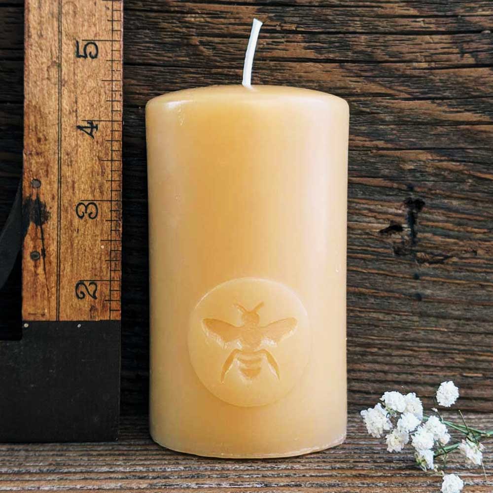 'Big Moon Bee' beeswax pillar candle, lit